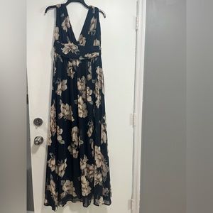 Long sleeveless, navy and tan floral dress worn to a formal wedding